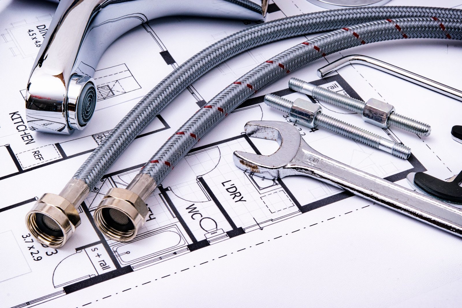 Plumbing wrenches and pipe tools laid out for a drain cleaning job, Las Vegas NV